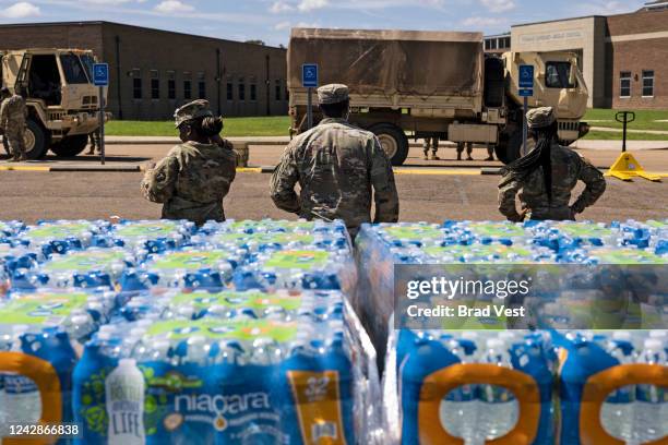 Members of the Mississippi National Guard hand out bottled water at Thomas Cardozo Middle School in response to the water crisis on September 01,...