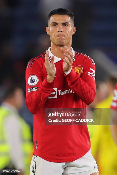 Manchester United's Portuguese striker Cristiano Ronaldo applauds supporters on the pitch after the English Premier League football match between...