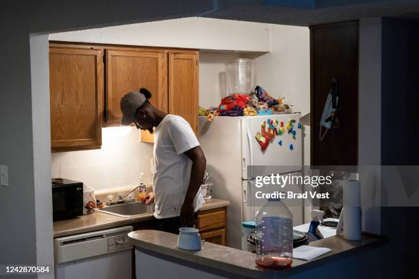 Terrence Carter rinses his hands off after washing dishes on September 01, 2022 in Jackson, Mississippi. The water pressure in Carters apartment...