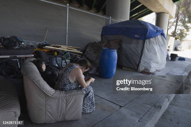 Homeless people in the shade under a freeway overpass during a heatwave in San Fernando, California, US, on Thursday, Sept. 1, 2022. After narrowing...