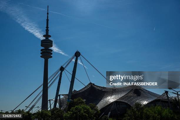 Photo taken on August 17, 2022 shows the Olympic Tower next to the Olympic Stadium with its tent roof construction at the Olympic Park in Munich,...