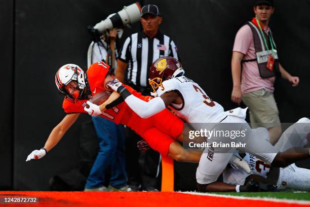 Wide receiver John Paul Richardson of the Oklahoma State Cowboys scores a touchdown against defensive back Trey Jones of the Central Michigan...