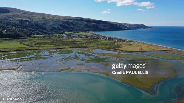 An aerial photograph taken on August 30, 2022 shows the coast and the village of Fairbourne, on Wales' northwest coast, which is predicted to flood...