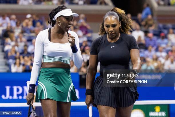 S Serena Williams and Venus Williams confer as they play against Czech Republic's Lucie Hradecka and Linda Noskova during their 2022 US Open Tennis...