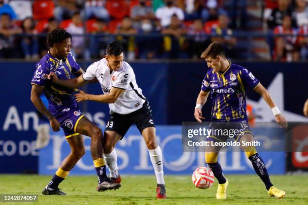 Ismael Govea of Tjuana competes for the ball with Abel Hernandez and Facundo Waller of Atletico San Luis during the 12th round match between Atletico...