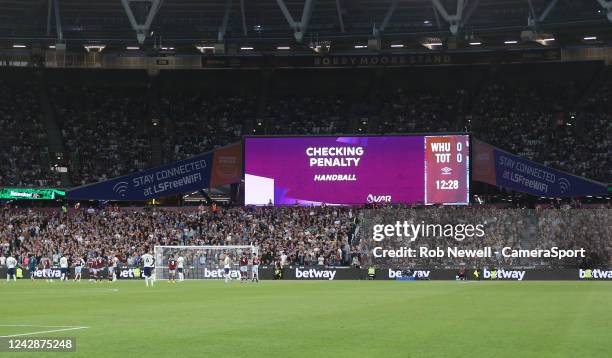 The big screen indicates VAR checking penalty during the Premier League match between West Ham United and Tottenham Hotspur at London Stadium on...