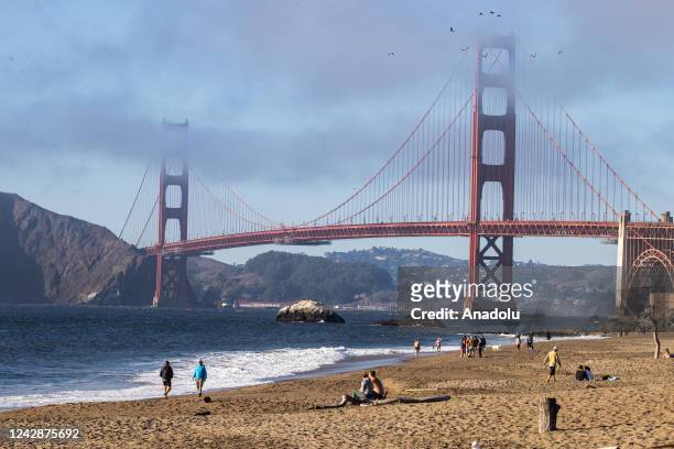 People enjoy on the Baker beach near the Golden Gate Bridge of San Francisco in California, United States on September 1, 2022 as the heat wave is...