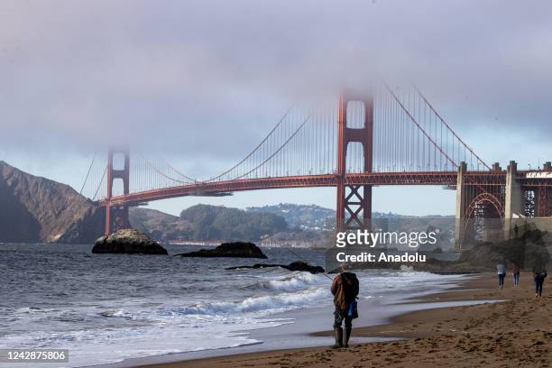 Man fishes on the Baker beach near the Golden Gate Bridge of San Francisco in California, United States on September 1, 2022 as the heat wave is...