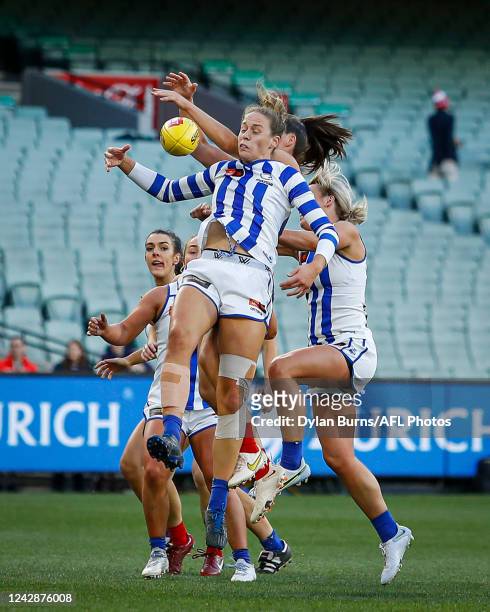 Kimberley Rennie of the Kangaroos, Kate Hore of the Demons and Sarah Wright of the Kangaroos compete for the ball during the 2022 S7 AFLW Round 02...