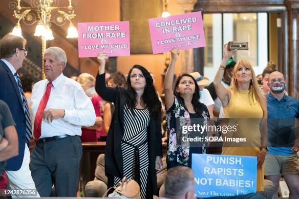 Protesters hold signs inside the South Carolina Statehouse as lawmakers debate an abortion ban. Pro-woman, Pro-choice and Pro-abortion protesters...