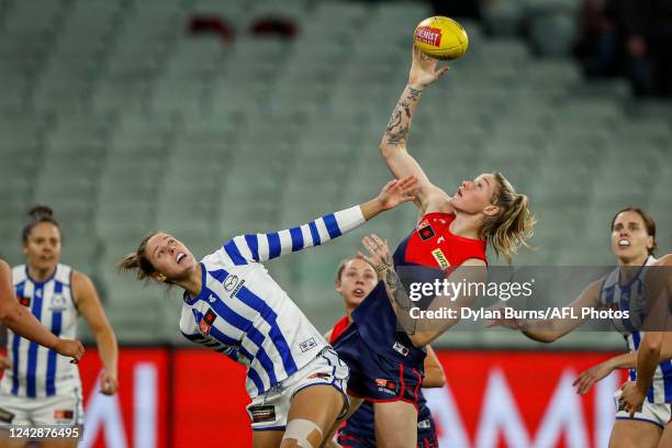 Kimberley Rennie of the Kangaroos and Tayla Harris of the Demons compete for the ball during the 2022 S7 AFLW Round 02 match between the Melbourne...