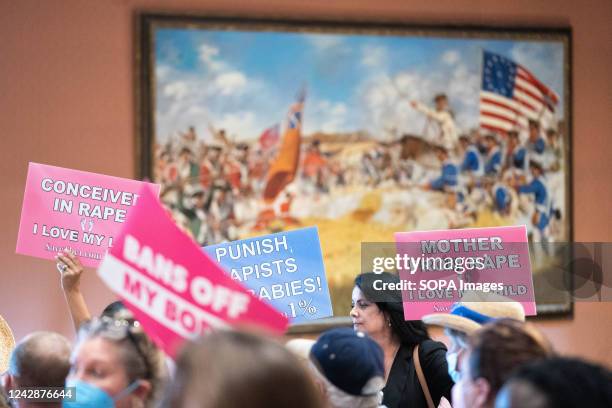 Protesters hold signs inside the South Carolina Statehouse as lawmakers debate an abortion ban. Pro-woman, Pro-choice and Pro-abortion protesters...