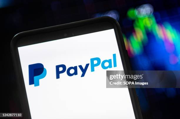 In this photo illustration a PayPal logo seen displayed on a smartphone.