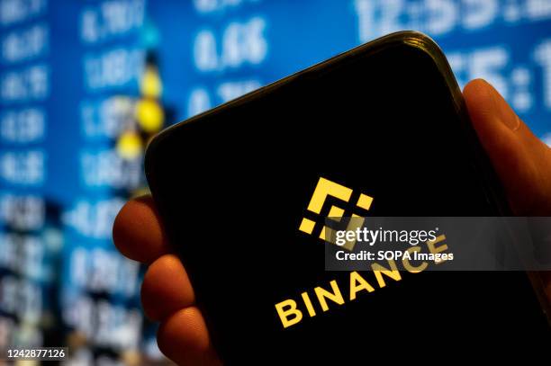 In this photo illustration, the cryptocurrency exchange trading platform Binance logo is displayed on a smartphone screen.