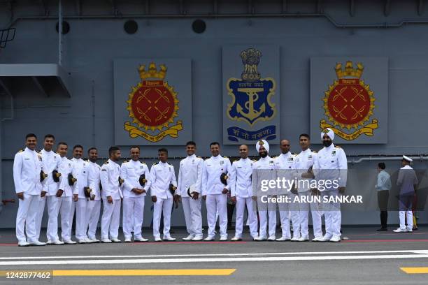 Indian Navy officers pose for a group picture on the deck of the Indian indigenous aircraft carrier INS Vikrant during its commissioning at Cochin...