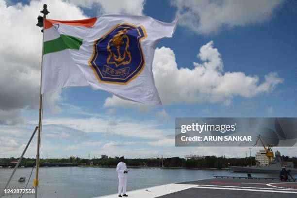 Indian Navy officer stands on the deck of the Indian indigenous aircraft carrier INS Vikrant during its commissioning at Cochin Shipyard in Kochi on...