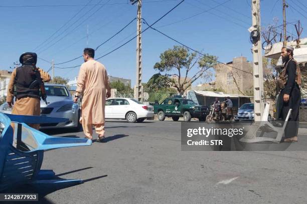 Taliban fighters block a road after a blast during the Friday prayer in Gazargah mosque, in Herat on September 2, 2022. - A huge bomb blast at one of...