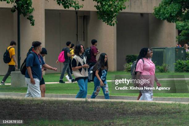 High school students walk on a campus in Plano, Texas, the United States, on Aug. 31, 2022. TO GO WITH Feature: Rising college cost, teacher shortage...