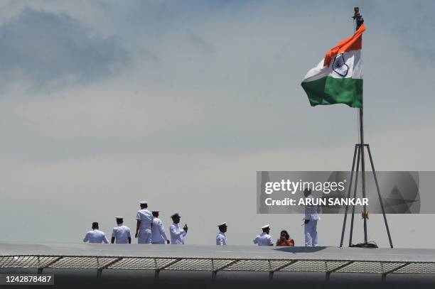 Indian Navy officers gather on the deck of the Indian indigenous aircraft carrier INS Vikrant during its commissioning at Cochin Shipyard in Kochi on...