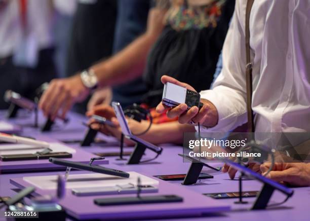 September 2022, Berlin: Numerous visitors look at new smartphone models at the electronics fair IFA. More than 1100 exhibitors show the novelties of...