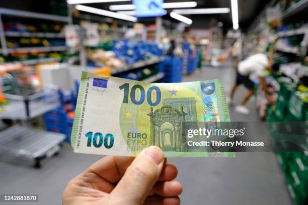 Euro banknote is seen in a supermarket in Etterbeek on September 2, 2022 in Brussels, Belgium. Across the European continent, prices are soaring. In...