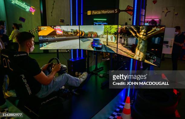 Visitor plays a game of Forza Horizon 5 on Oled Flex tv monitors at the stand of South Korean consumer goods giant LG at the Internationale...
