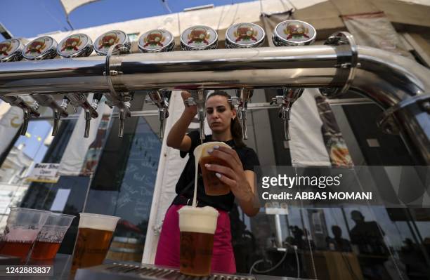 Bartender serves visitors on September 2 during the annual annual Oktoberfest beer festival in the village of Taybeh in the village of Taybeh, east...