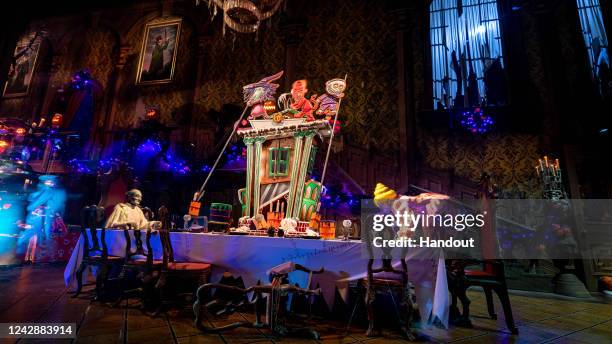 In this handout photo provided by Disney Resorts, a gingerbread house is displayed on the ballroom table inside the Haunted Mansion at Disneyland...