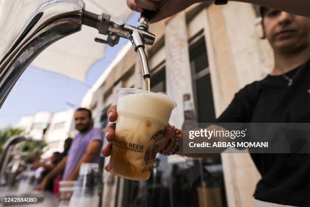 Bartender serves visitors on September 2 during the annual annual Oktoberfest beer festival in the village of Taybeh, east of the occupied West Bank...