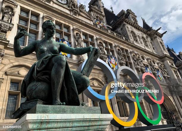 The Olympic Rings are dislayed next to the "La Science" statue by Jules Blanchard at the Hotel De Ville in Paris on September 2 the city that will...