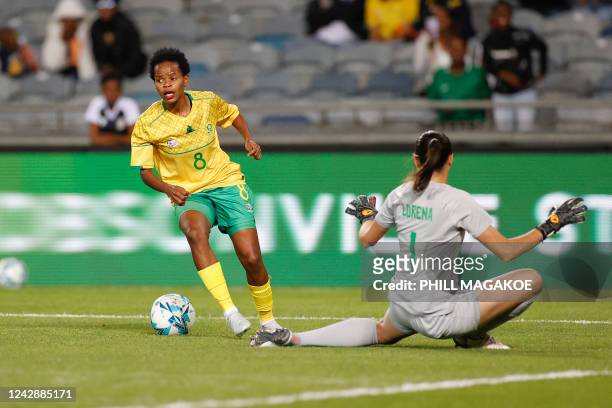South Africas Hildah Mhlongo shields the ball from Brazils goalkeeper Lorena da Silva Leite during the women's international friendly football match...