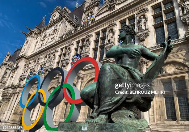 The Olympic Rings are displayed next to the "L'Art" statue by Laurent Marqueste at the Hotel De Ville in Paris on September 2 the city that will host...