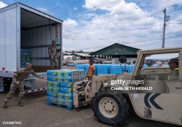 Mississippi National Guard troops unload a pallets of water at the State Fair Grounds in Jackson, Mississippi, on September 2, 2022. - Residents of...