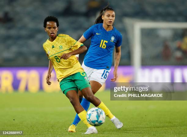 South Africas Hildah Mhlongo kicks the ball away from Brazils Beatriz Zaneratto Joao during the women's international friendly football match between...