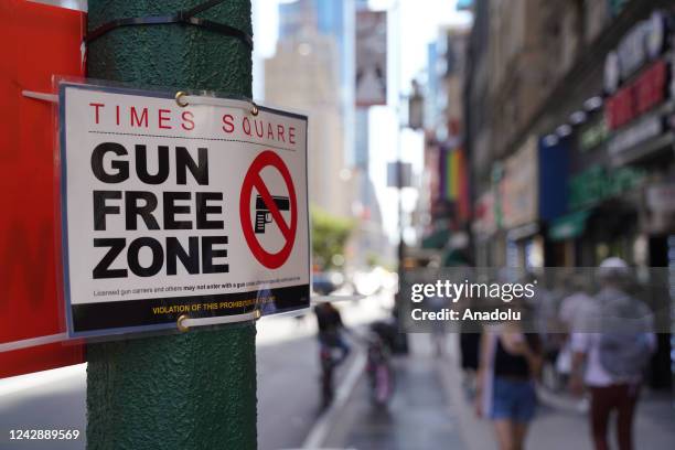 Signs announcing a "gun-free zone" were posted at every entry and exit point of the Times Square area as a New York law limiting where firearms can...