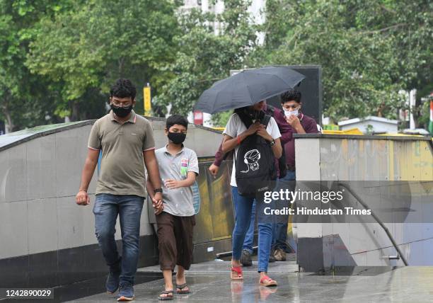 Pedestrian covers himself with an umbrella during monsoon rain, at CP on September 2, 2022 in New Delhi, India. Heavy rains lashed parts of Delhi -...