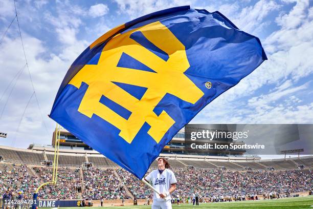 Cheerleader celebrates by waving a Notre Dame Fighting Irish flag during the Notre Dame Blue-Gold Spring Football Game on April 23, 2022 at Notre...