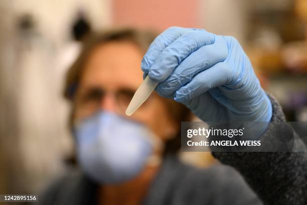 Professor Monica Trujillo holds up a wastewater sample at a lab at Queens College on August 25 in New York City. - Since the first polio case was...