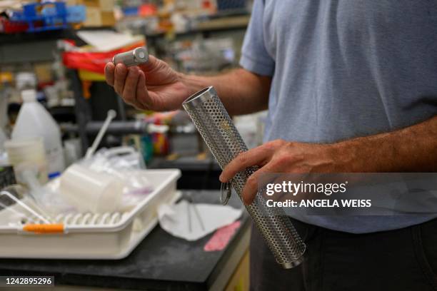 Professor of Biology John Dennehy holds a tool for wastewater collection at a lab in Queens College on August 25 in New York City. - Since the first...