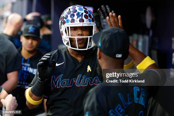 Jerar Encarnacion of the Miami Marlins wears the football helmet following a solo home run during the third inning against the Atlanta Braves at...