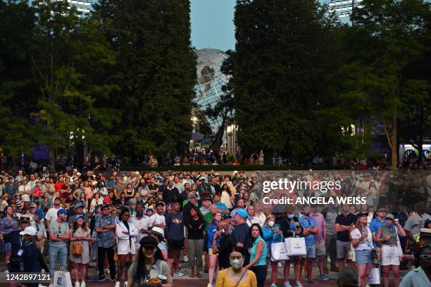 People watch in a screen the 2022 US Open Tennis tournament women's singles third round match between USA's Serena Williams and Australia's Ajla...