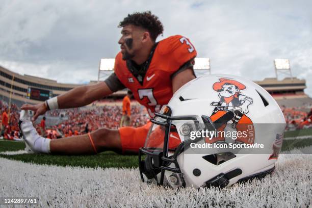 Oklahoma State Cowboys quarterback Spencer Sanders stretches by his helmet prior to the game against the Central Michigan Chippewas on September 1st,...