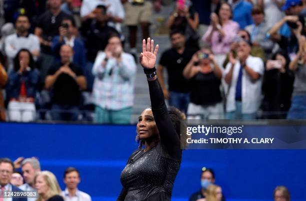 S Serena Williams waves to the audience after losing against Australia's Ajla Tomljanovic during their 2022 US Open Tennis tournament women's singles...