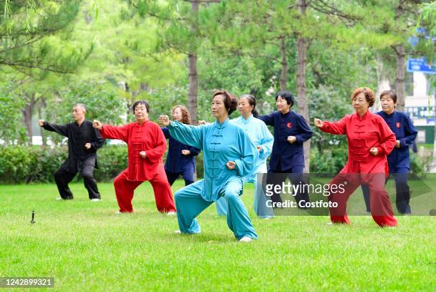 Fitness enthusiasts take a morning exercise at a park in Ordos, Inner Mongolia, China, Sept 3, 2022.