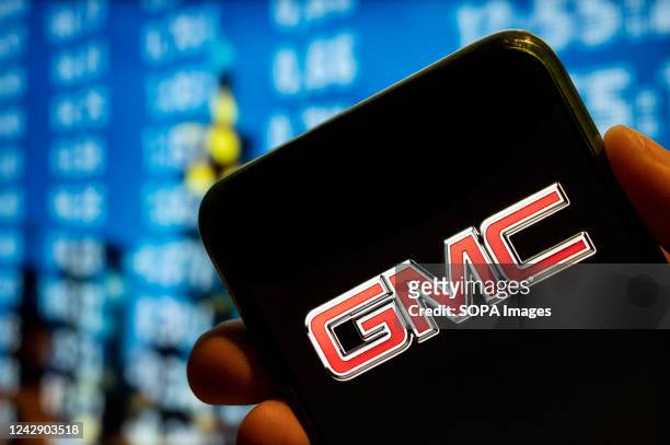 In this photo illustration, the American automobile manufacturer company General Motors GMC logo is displayed on a smartphone screen.