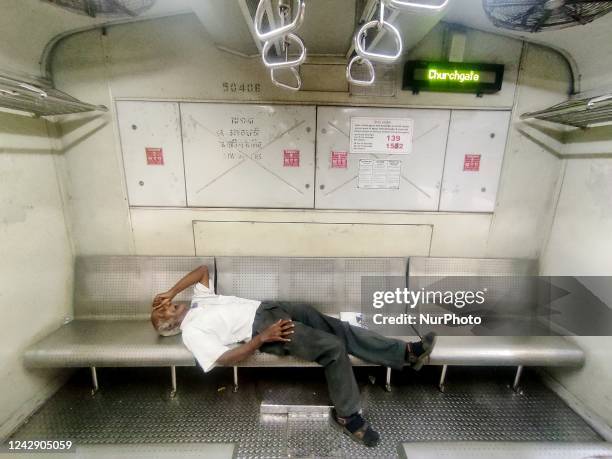 Man sleeps inside a suburban train compartment in Mumbai, India, 03 September, 2022