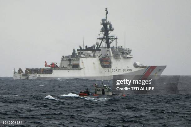 Coast guard cutter Midgett and a boat maneouver during a joint search and rescue exercise between the Philippine and US coast guards in the vicinity...