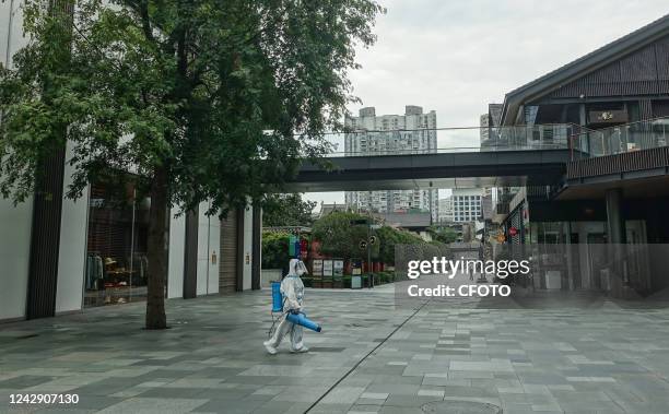 Volunteer disinfects a street in Chengdu, Sichuan Province, China, Sept 3, 2022. The city of Chengdu is temporarily closed because of the virus.