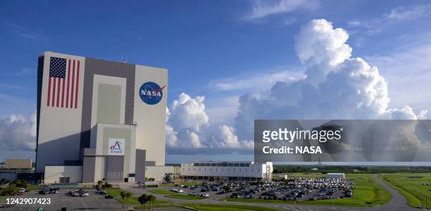 In this NASA handout, NASA's Vehicle Assembly Building , and the Launch Control Center, are seen in the foreground as NASA's Space Launch System...