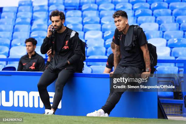 Mohamed Salah of Liverpool and Roberto Firmino of Liverpool sit together after the Premier League match between Everton FC and Liverpool FC at...